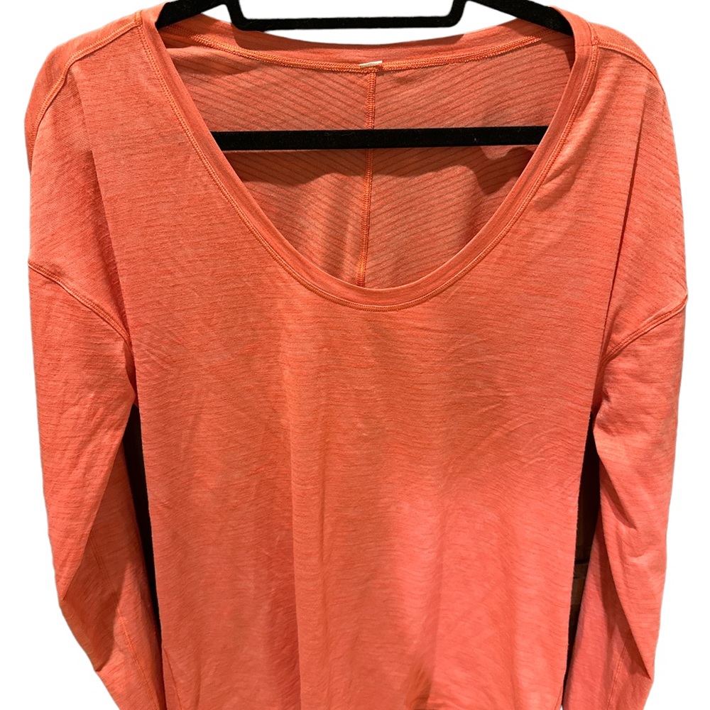 Lululemon Women’s orange long sleeved pullover athletic top . Relaxed fit .